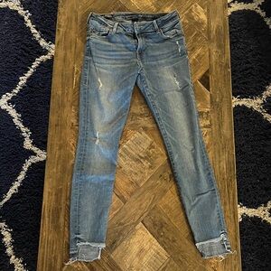 True Religion distressed Light Blue Skinny Jeans with high-low cut around ankles